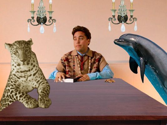 Collaged image where Chris E. Vargas sits at a table with a leopard and a dolphin. Chris is a Latinx person with short hair and light skin. Chris's hands rest on a book and a pile of gold coins is beside his elbow.