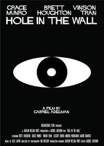 It is a black background with a white oval. Inside the oval is a black cirlce, and inside the circle is a white dot, altogether resembling an eye. The title is above it written in white "Hole in the Wall". The poster also says "A film by Gabriel Adelman".