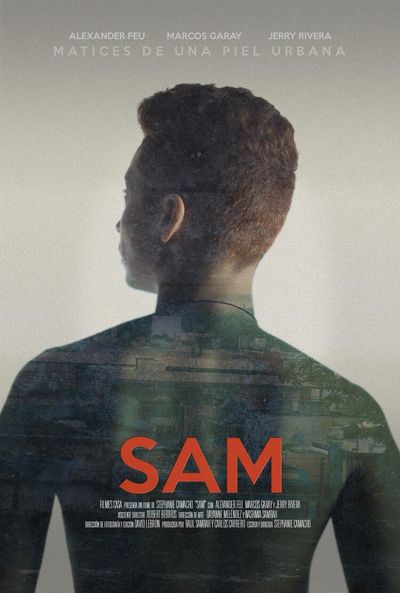 A person has their back to the camera looking off to the left side and the background is blank white. The person has light skin and natural red hair and they are shirtless with a projected image on their back to simulate a shirt. The image appears to be a bunch of different buildings.